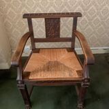 Antique armchair in carved wood and straw seat