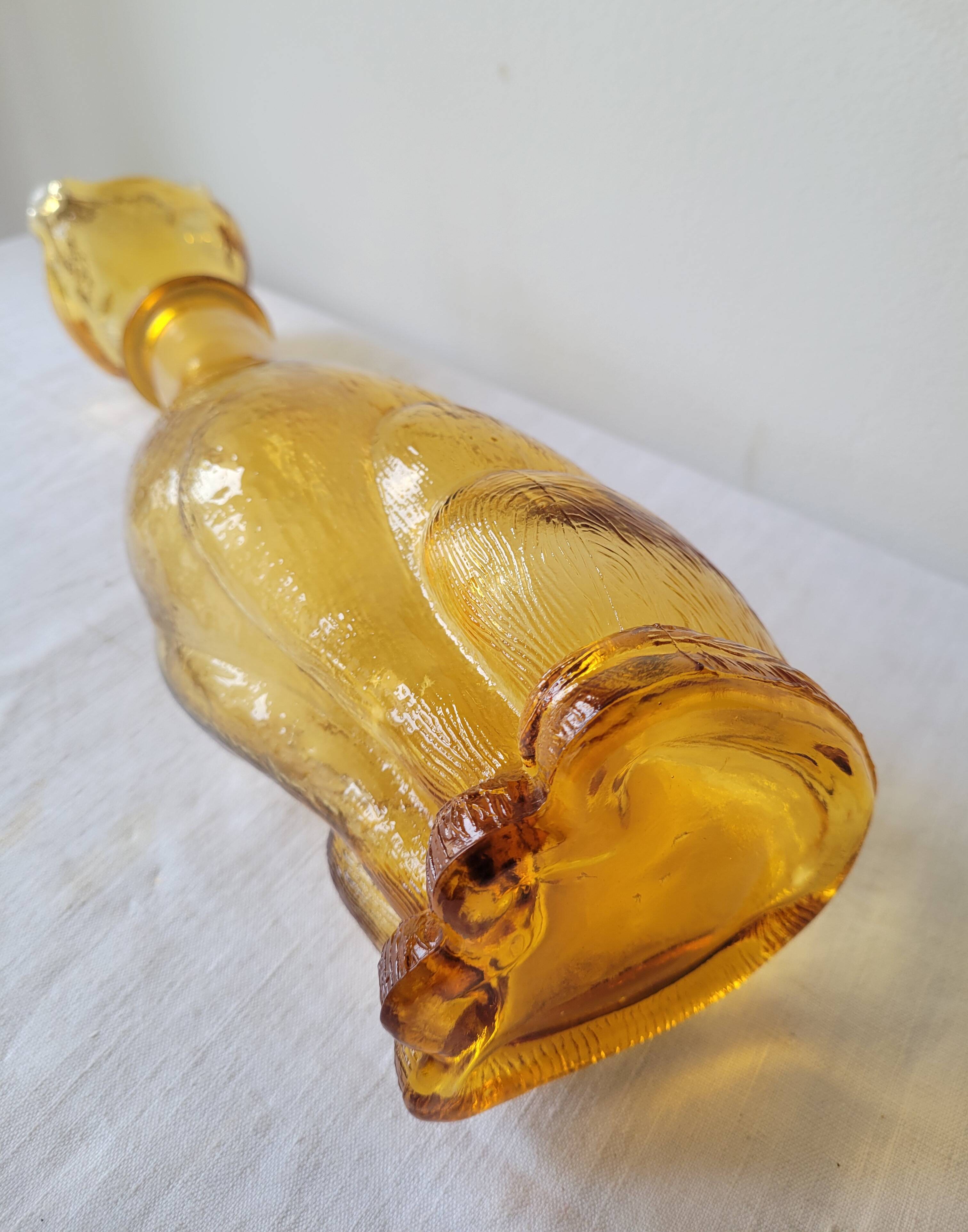 Zoomorphic carafe in amber glass
