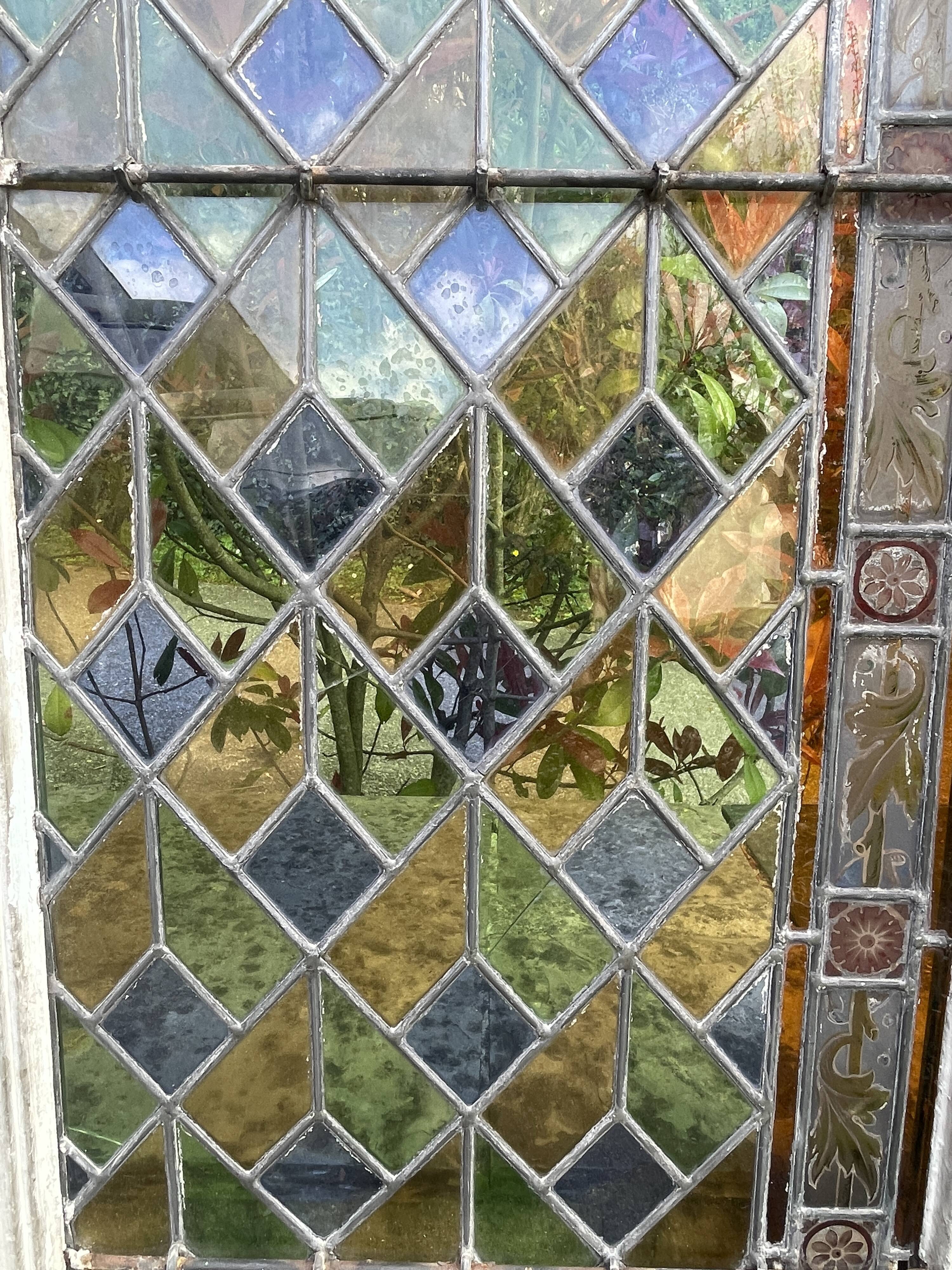 Pair of old double stained glass doors. Metal frames. Stained glass windows