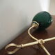 Desk lamp in brass with a swan neck and green opaline glass.