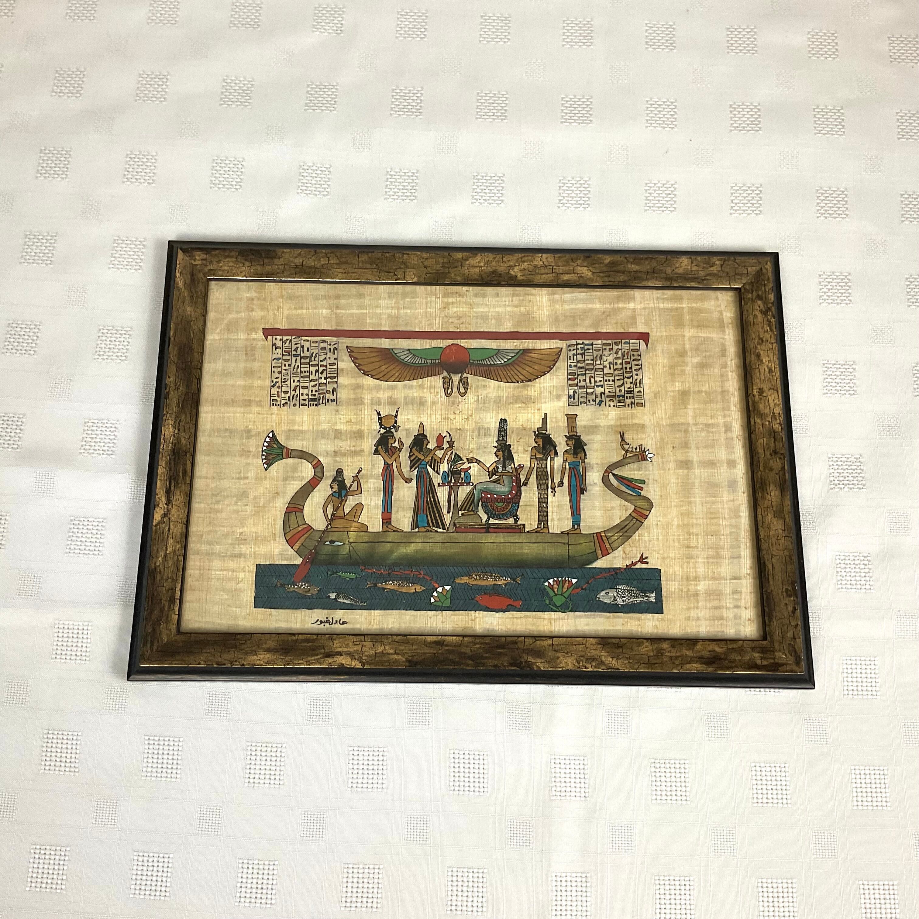 Egyptian papyrus under glass in wooden frame