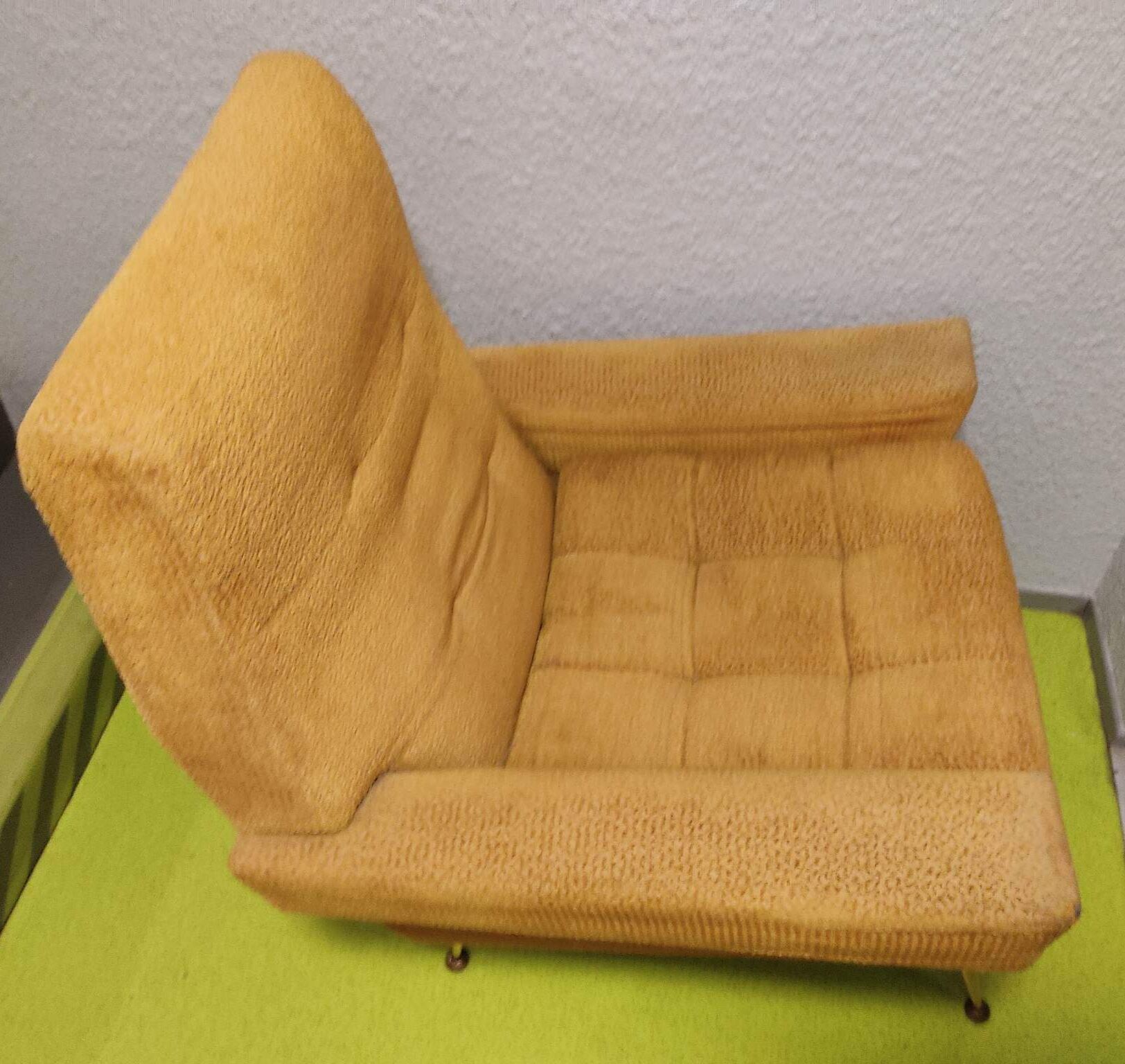Old velvet heating chair on metal legs