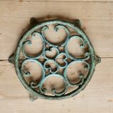 Antique round turquoise cast iron trivet.