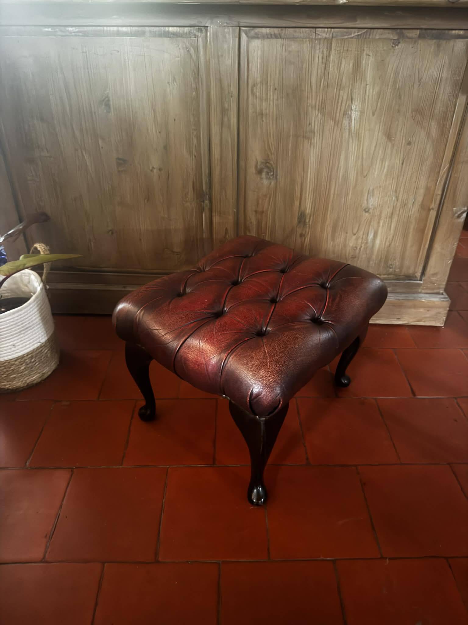 Red leather footrest in Chesterfield style, vintage 1970s.