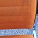 Pair of designer armchairs in orange fabrics and chrome tubes from the 70s