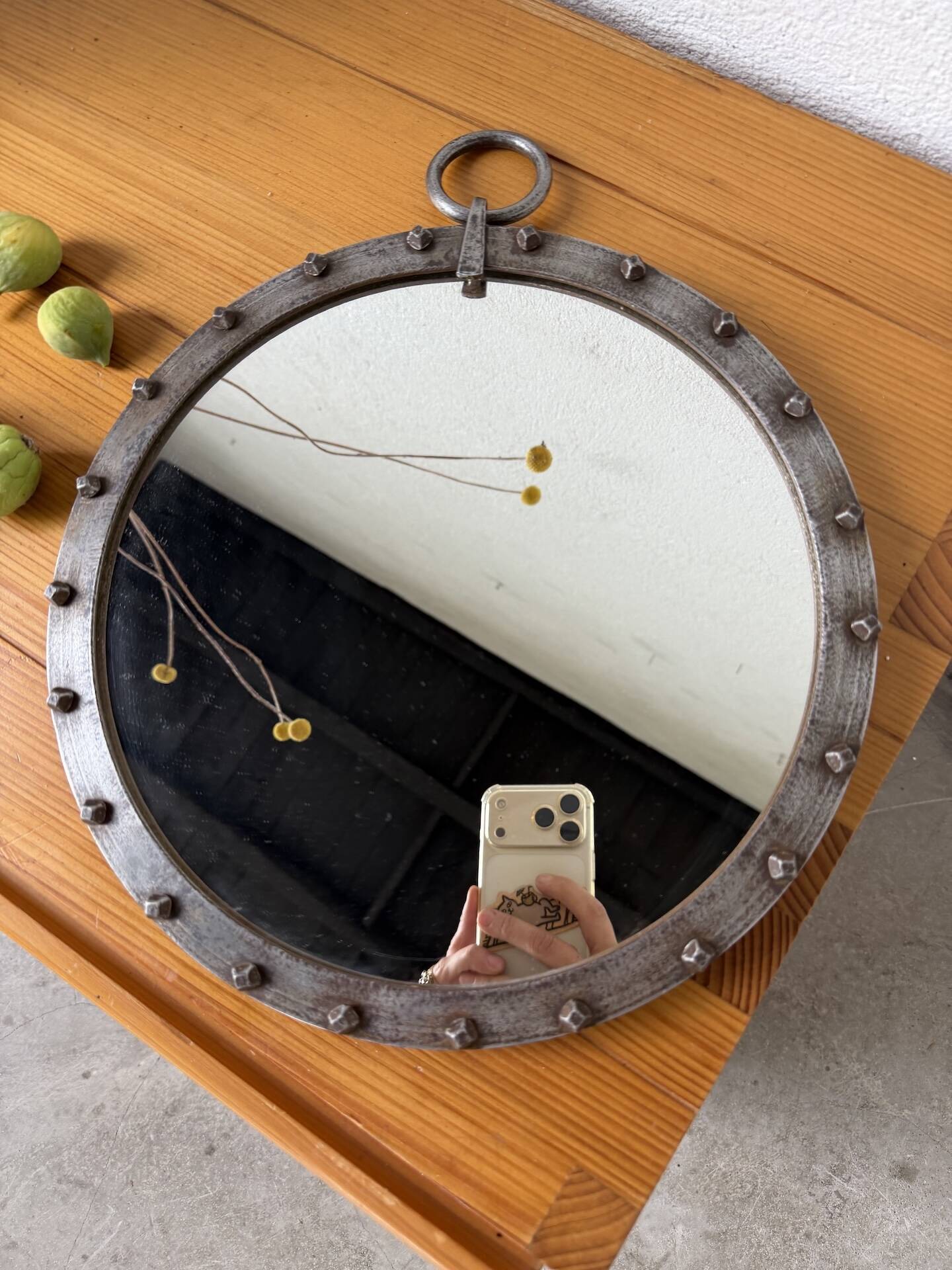 Brutalist round mirror with wrought iron and studs.