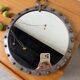 Brutalist round mirror with wrought iron and studs.