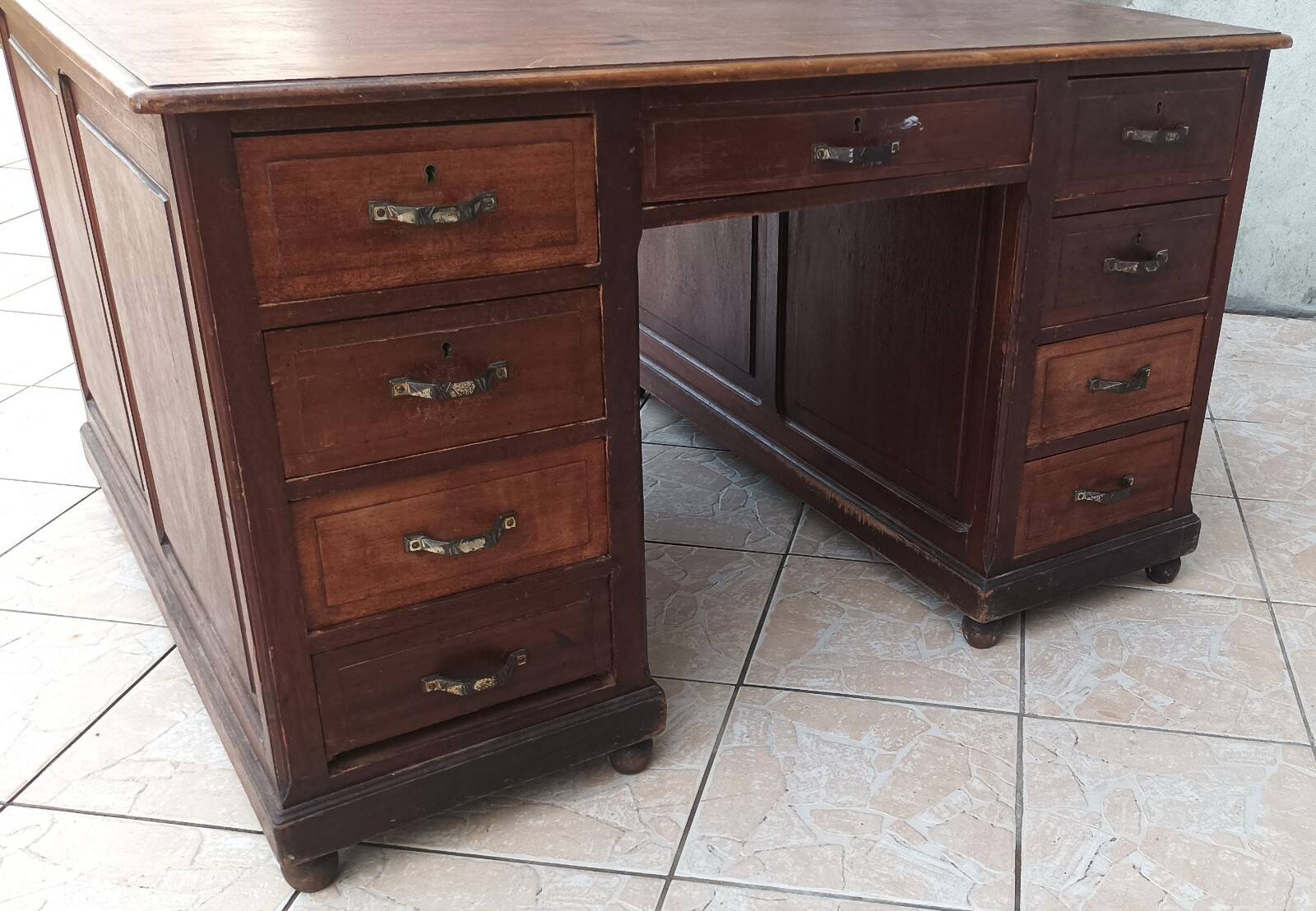Vintage double-sided mahogany desk with 18 drawers.