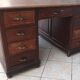 Vintage double-sided mahogany desk with 18 drawers.