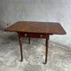 Antique drop-leaf side table on wheels