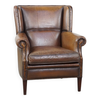 Fauteuil en cuir de mouton avec finition clous décoratifs