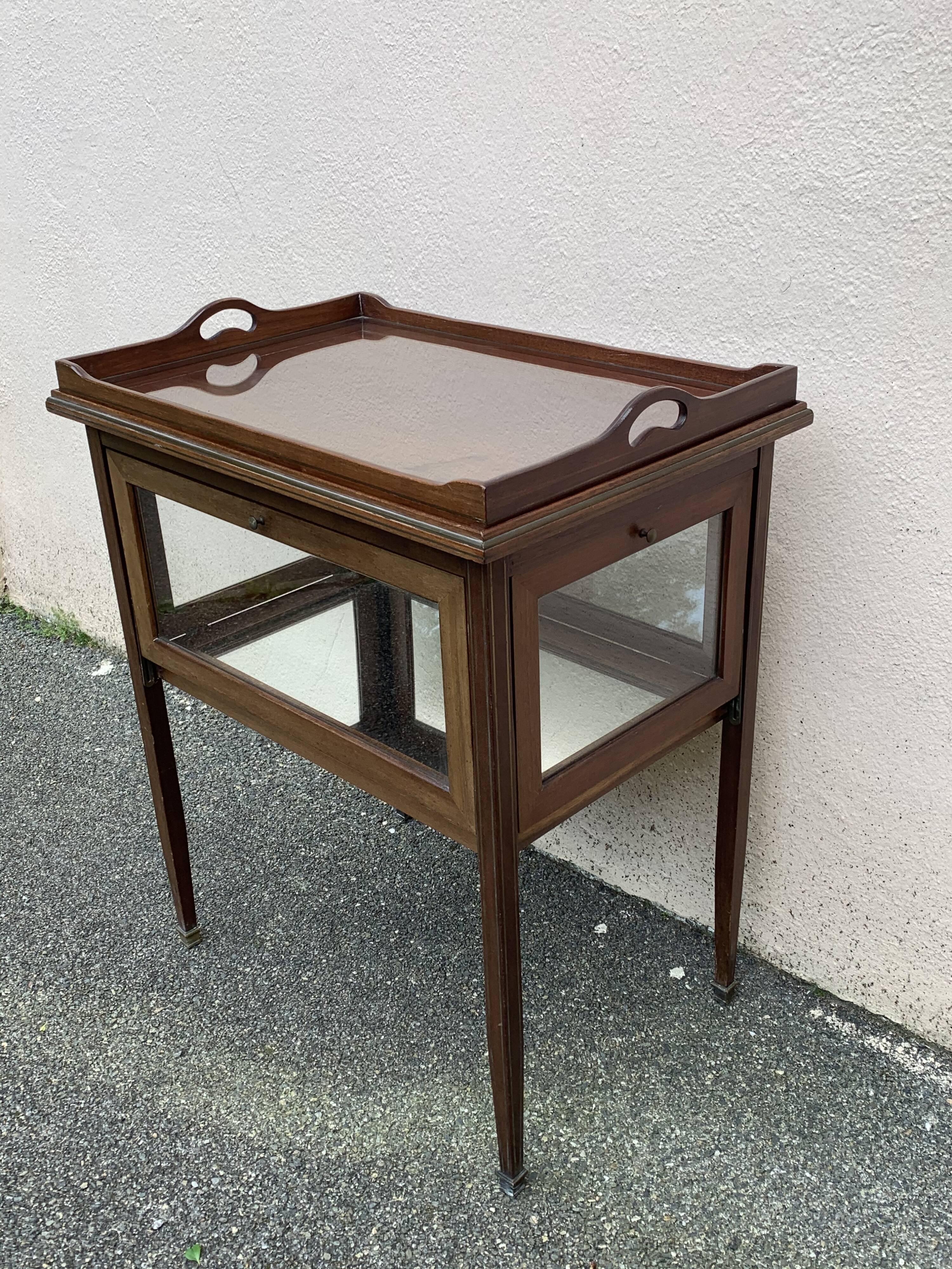 Glass-enclosed old tea table with wooden tray, bronze and brass
