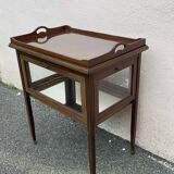Glass-enclosed old tea table with wooden tray, bronze and brass