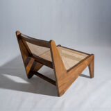 Reclined armchair in canned teak in natural wood