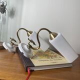 Pair of swan neck wall lights in brass, white glass and porcelain.
