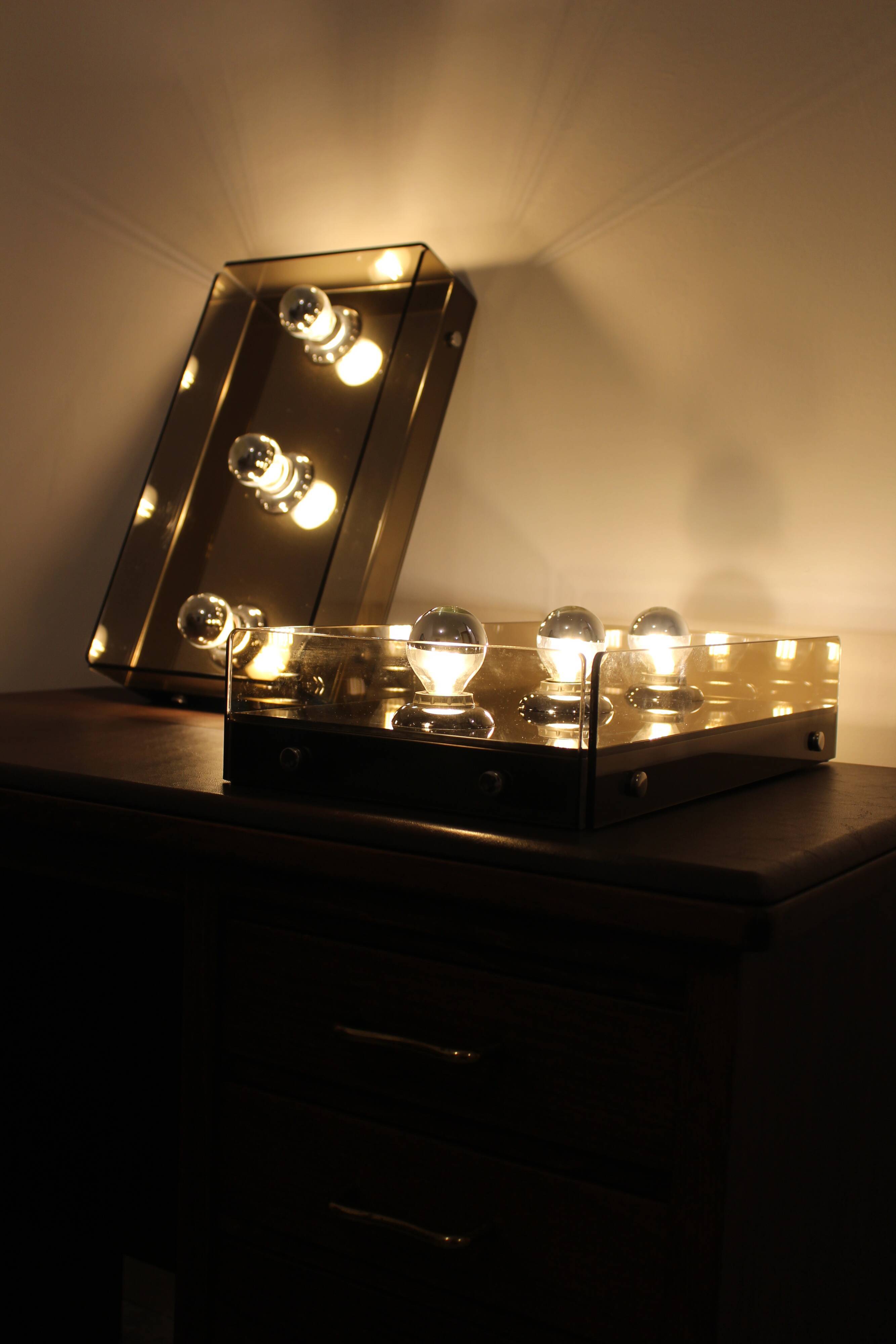 Pair of smoked glass wall lamps, mirrored bottom, Italy 70s