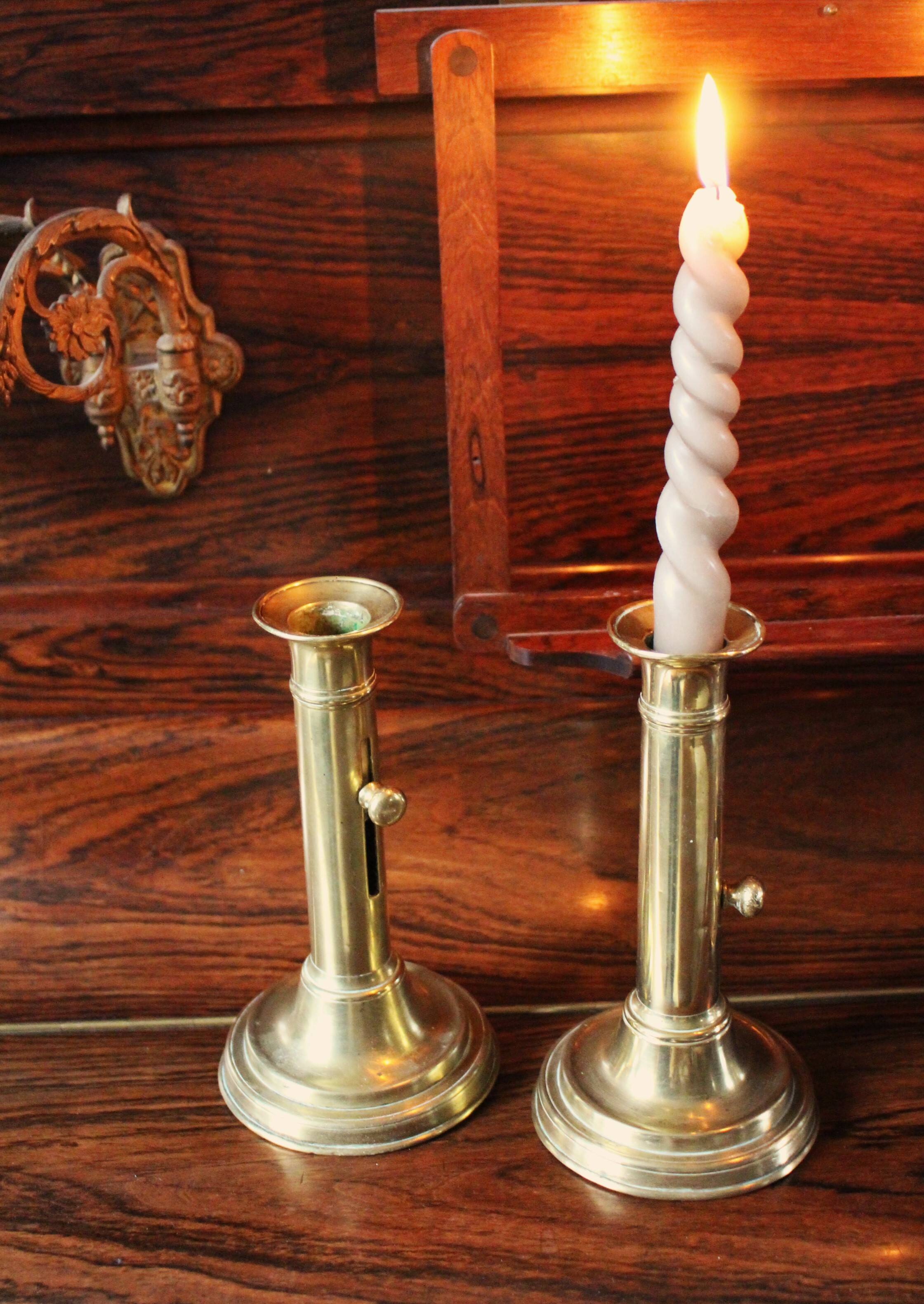 Pair of brass push-button candlesticks