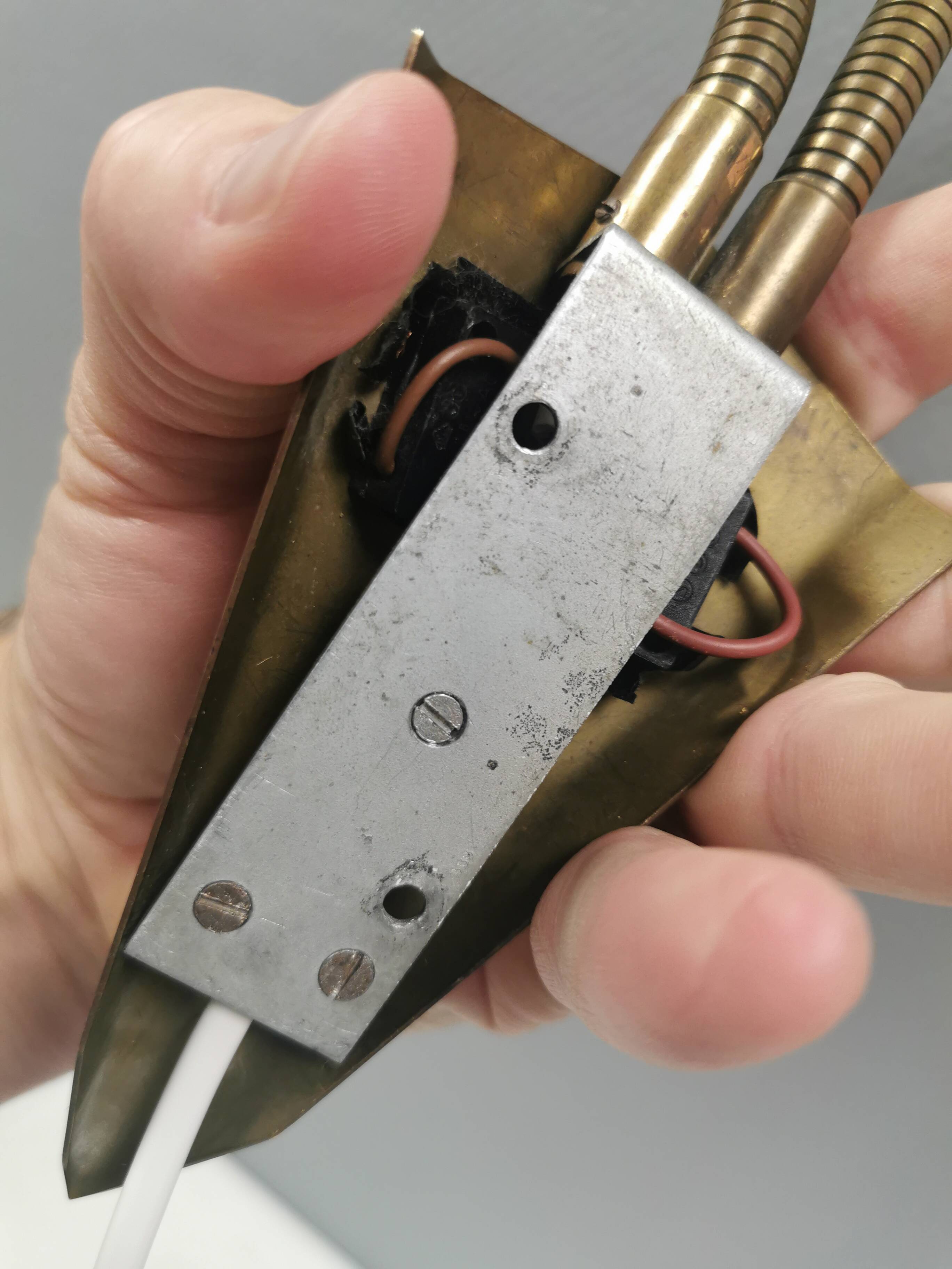 Older wall lamp with black metal shades and brass bend ‘arms’