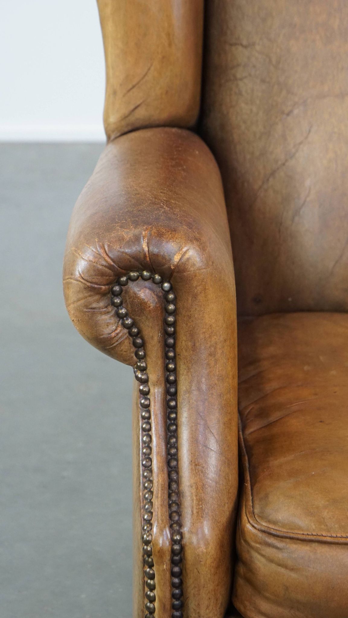 Patinated sheep leather wingback armchair