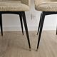 Pair of vintage barrel chairs in boucle fabric with brass splayed legs.