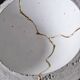 Concrete cup, tinted waxed, inlaid with gold leaf drips in a Kintsugi inspiration