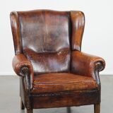Cognac-colored vintage sheep leather wingback chair with character