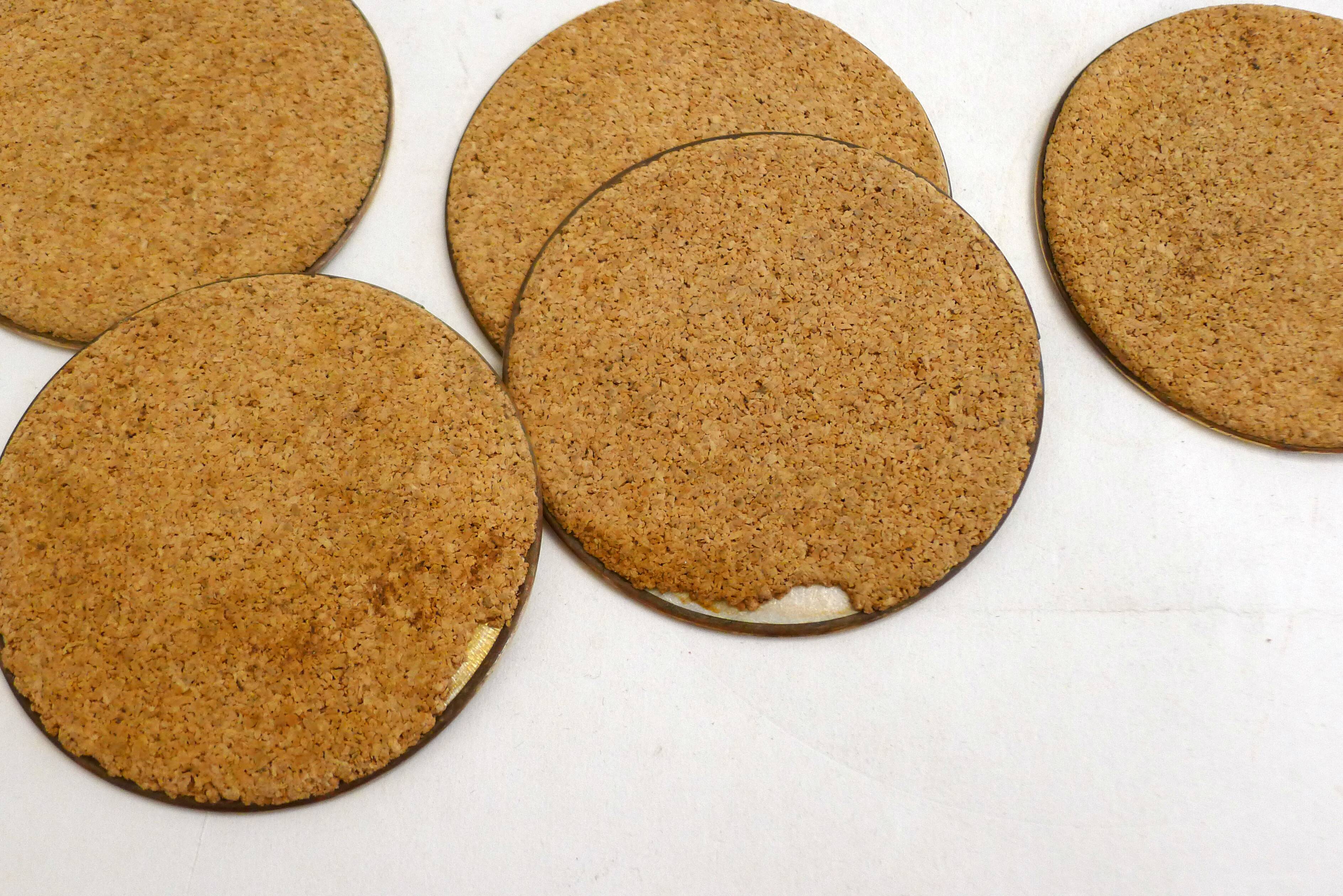 Set of 12 Mother of Pearl coasters with brass edging.