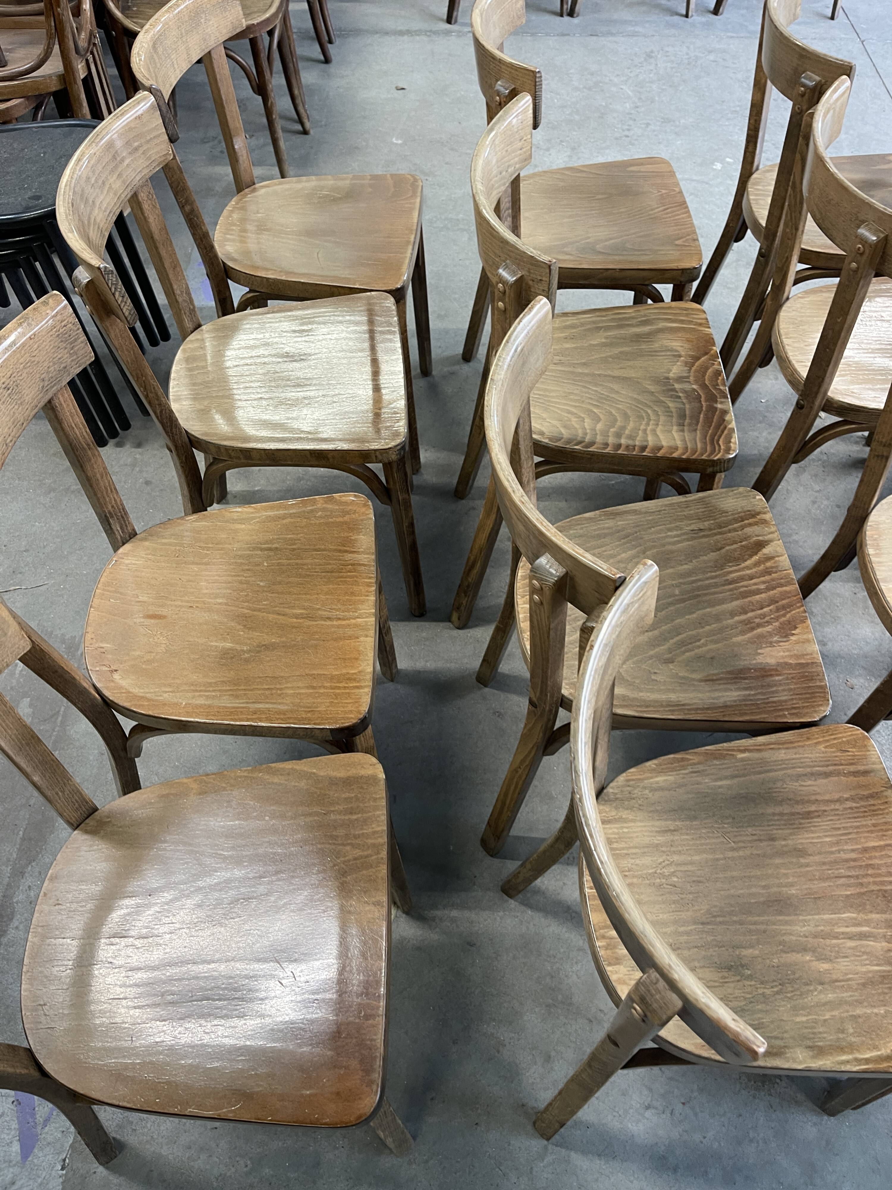 Set of 26 Baumann wooden bistro chairs from the 1950s France