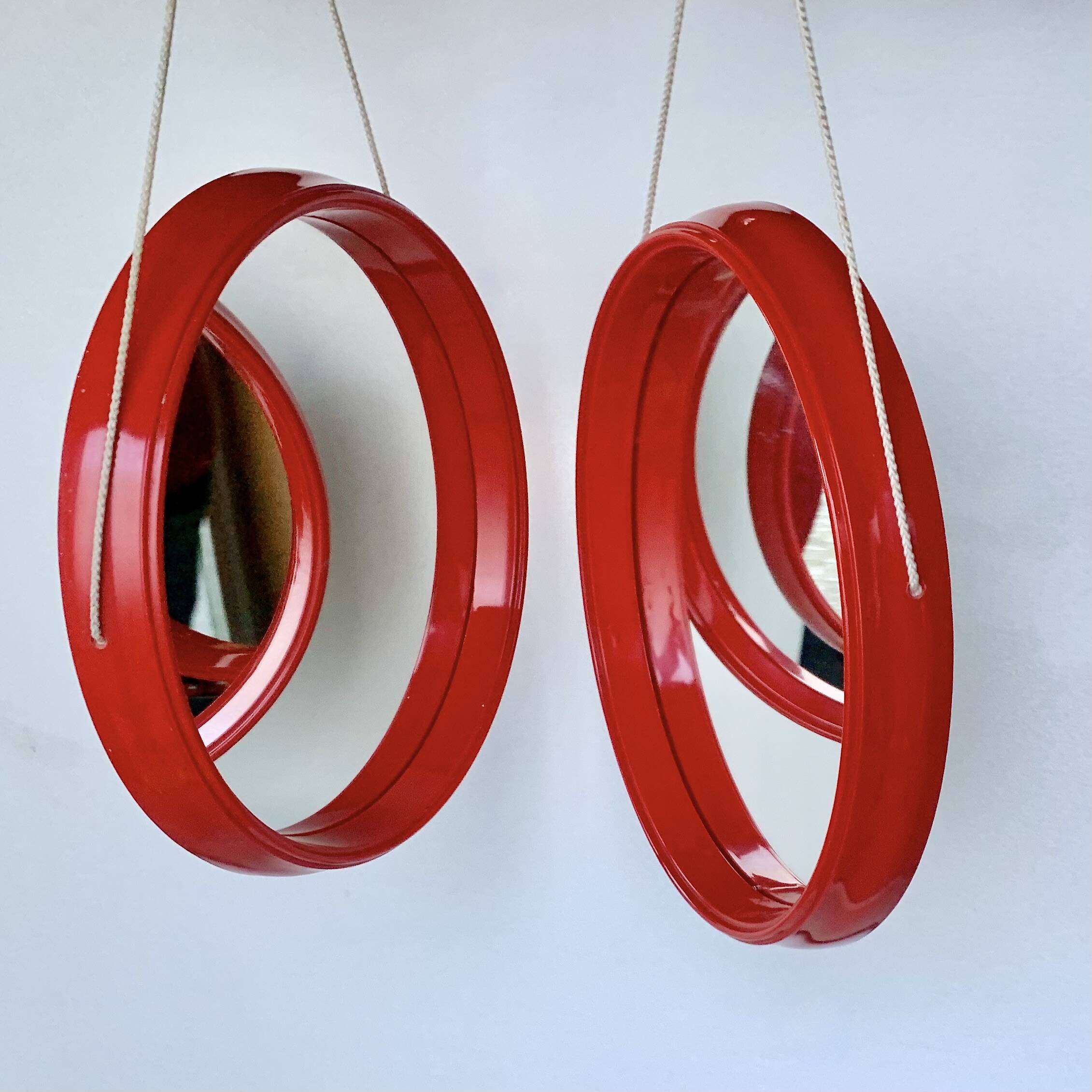 Pair of vintage round red plastic mirrors