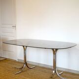Dining table with smoked glass top and chrome base.