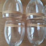 Set of 6 glasses with gold band decorations.