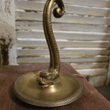 Small table lamp with a brass fish base and a tulip shade with green edges.