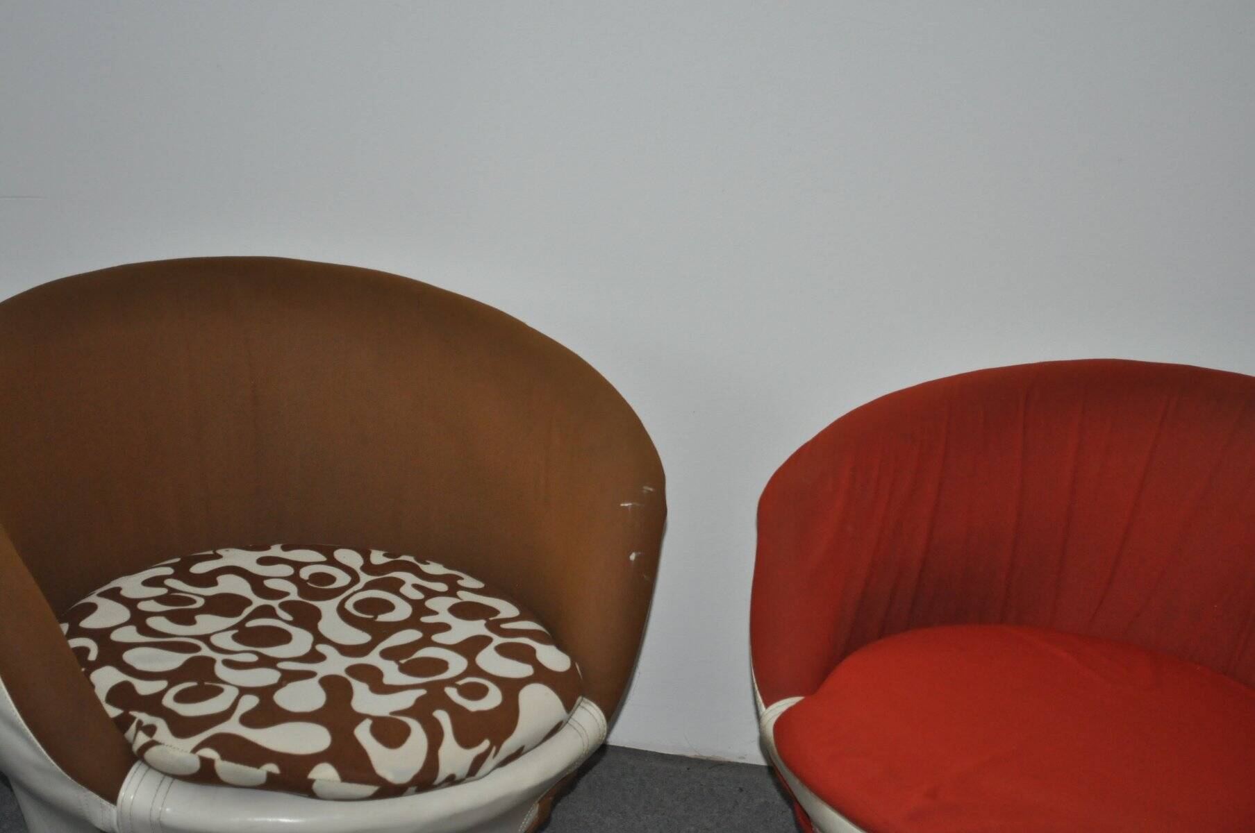 Set of 2 vintage 1970s tub chairs in brown, red, and white fabric with a enveloping silhouette.