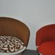 Set of 2 vintage 1970s tub chairs in brown, red, and white fabric with a enveloping silhouette.