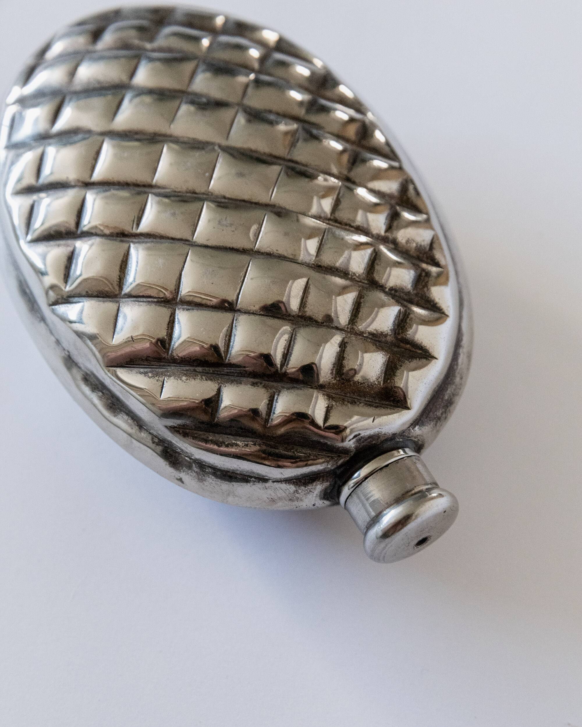 Vintage 1950s silver-plated flask in the shape of a pine cone.