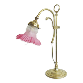 Vintage gooseneck lamp in brass with its raspberry-colored glass lampshade