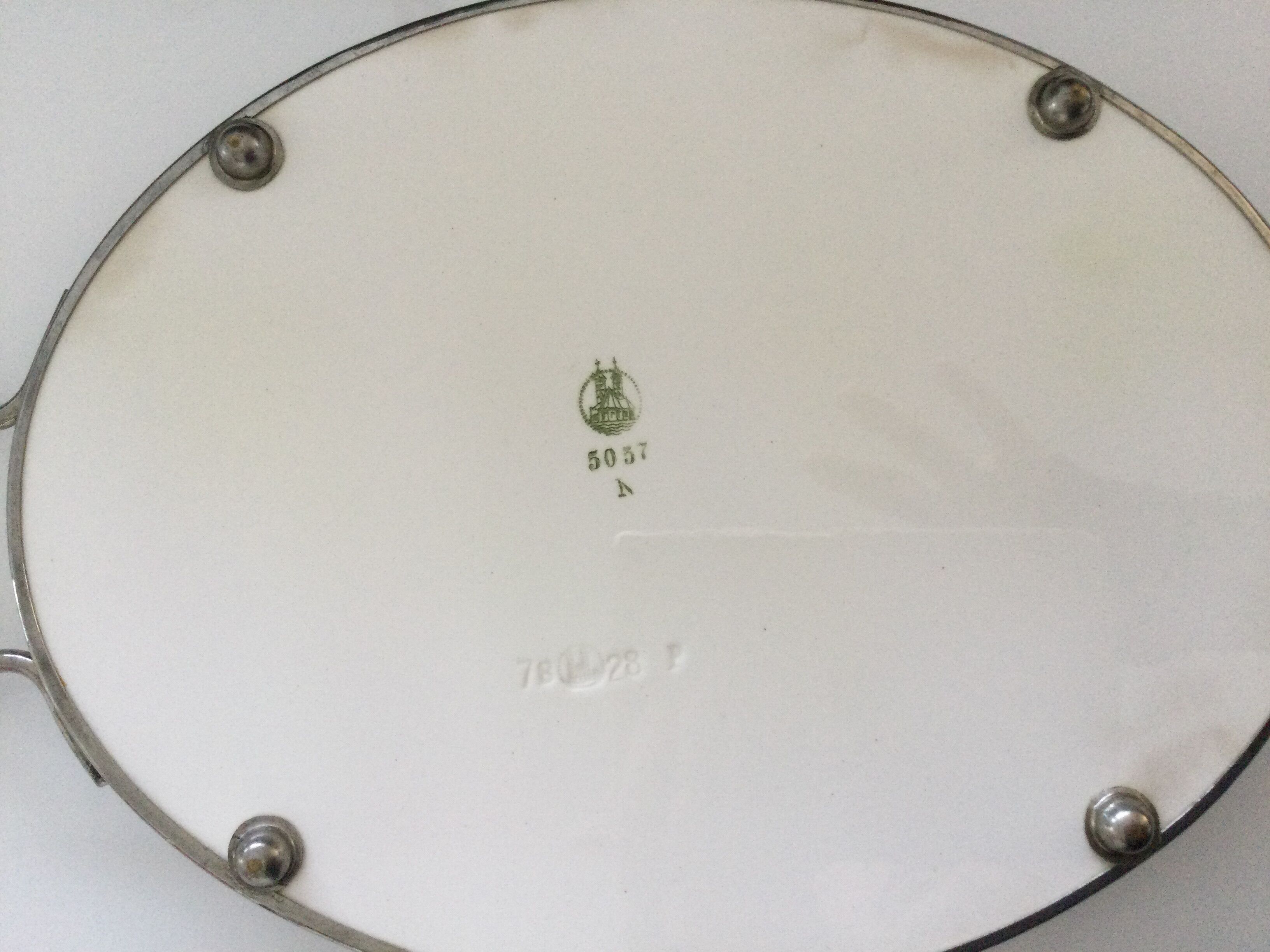 Vintage earthenware tray surrounded by antique metal