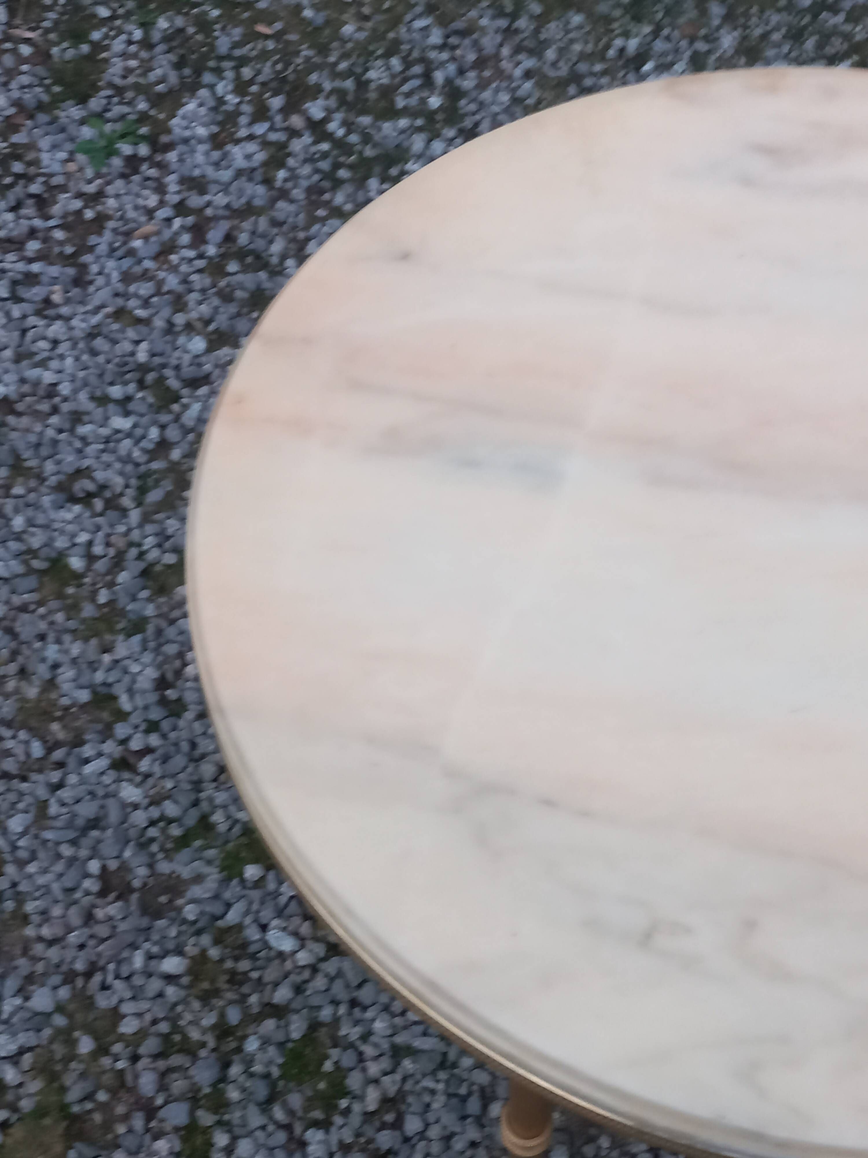Round neoclassical coffee table with a marble top and golden metal base.
