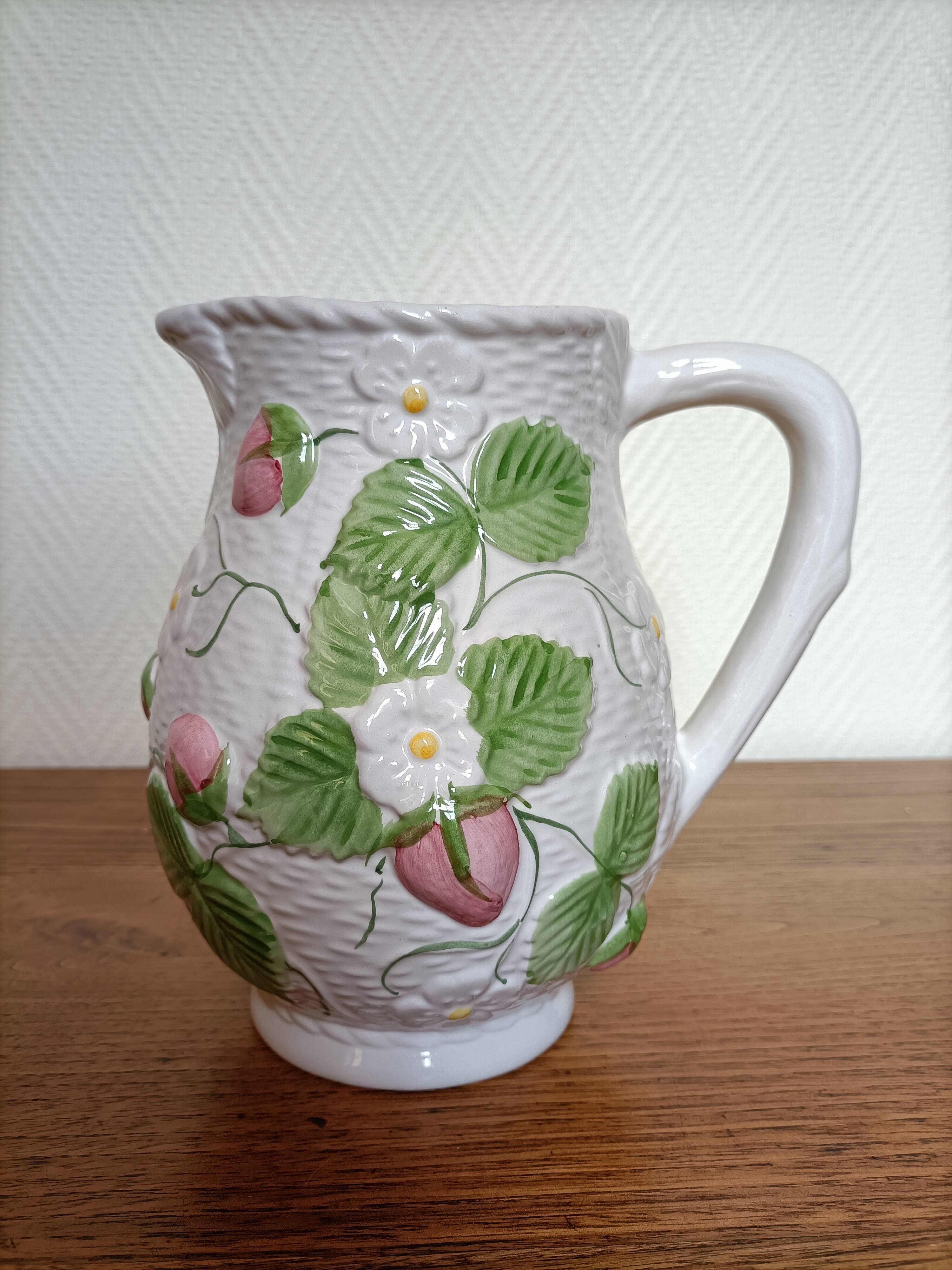 Barbotine pitcher with pastel flower decoration