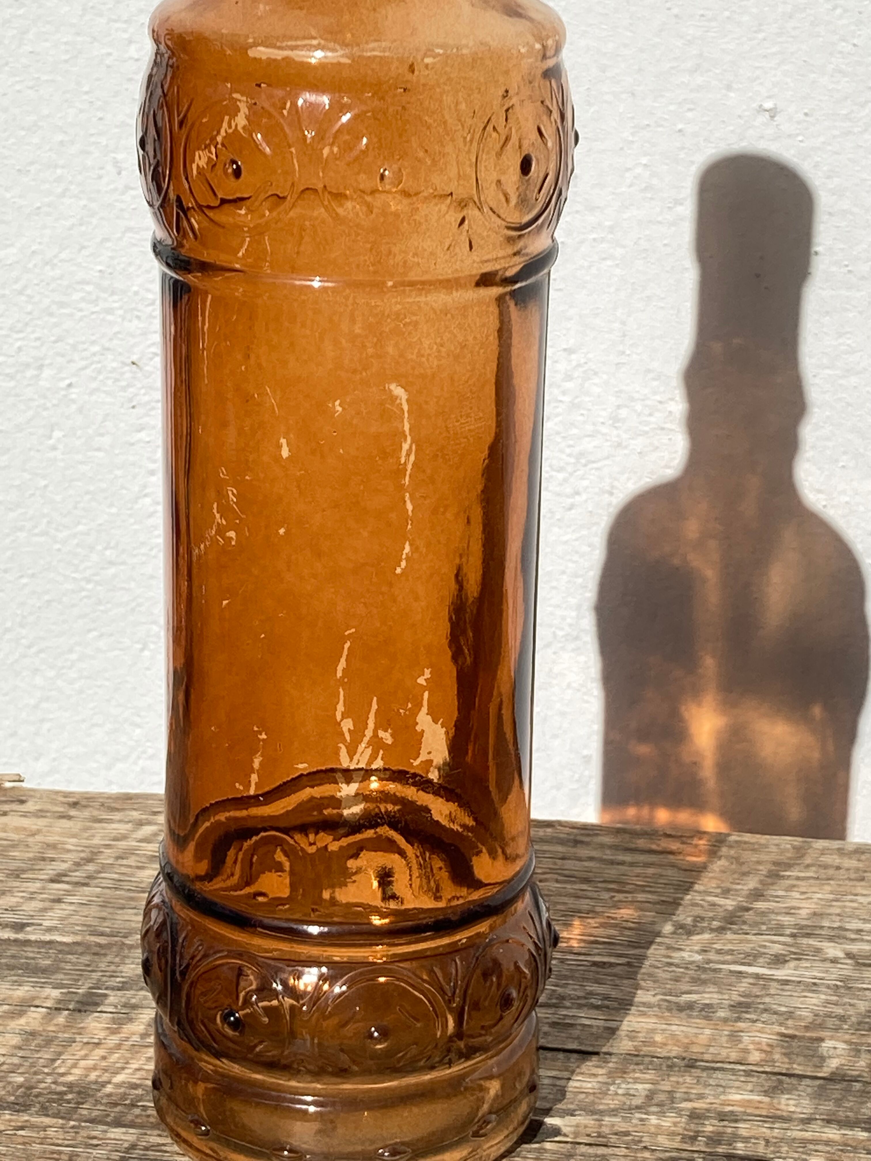 Vintage amber bottle in patterned brown glass