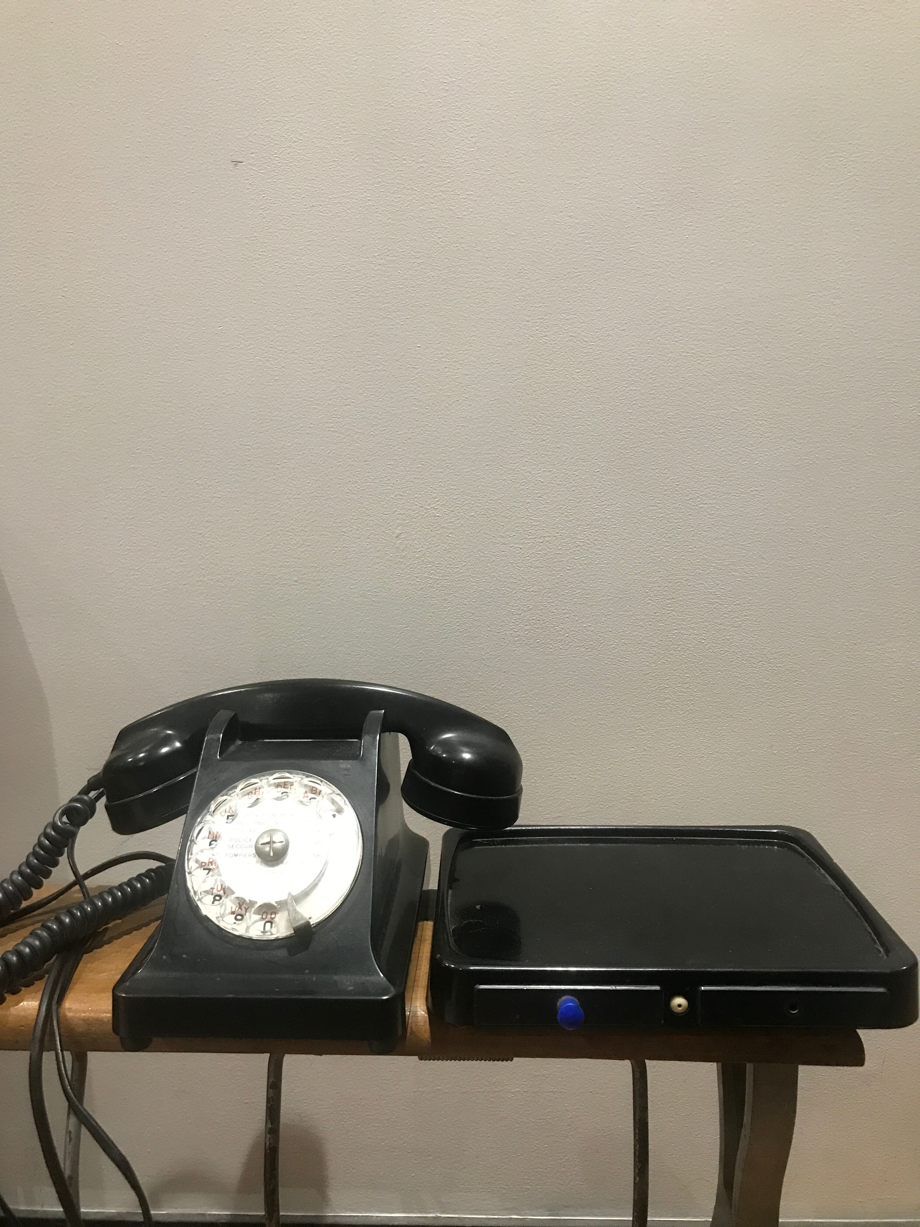 Black bakelite dial telephone with support