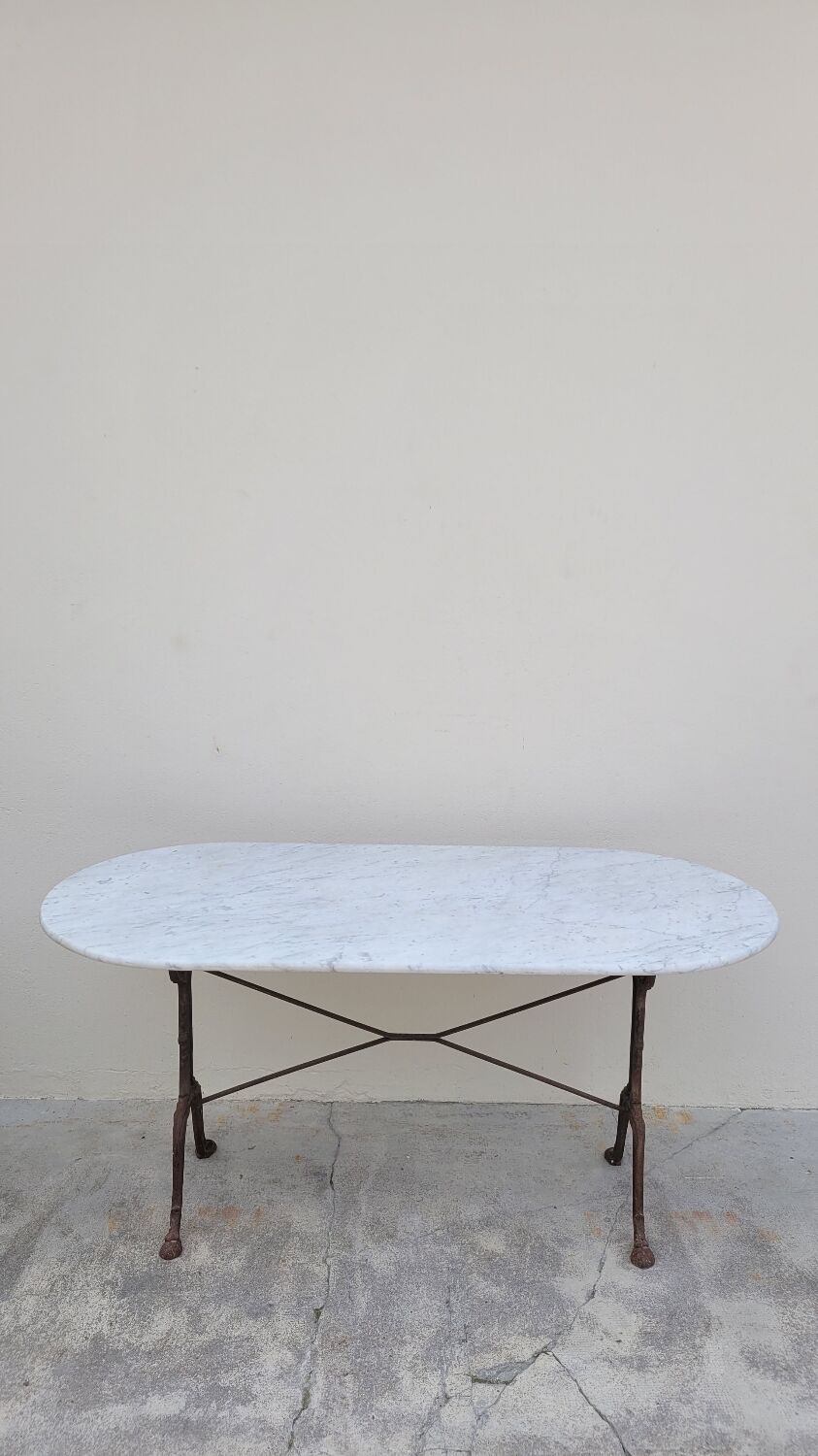 Restaurant bistro table in oval marble and decorated cast iron bases -1m51