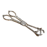 Sugar tongs or ice tongs in silver-plated metal.