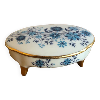 Small oval candy box on feet with blue and gold flowers