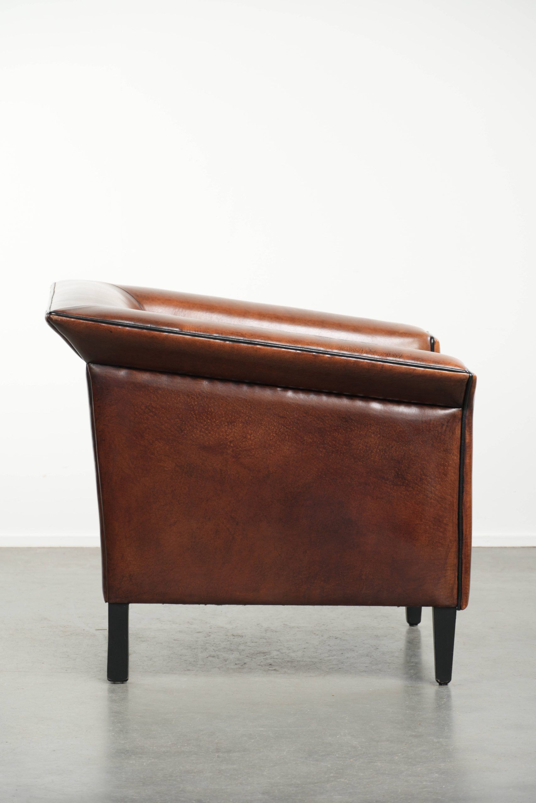 Sleek sheepskin Art Deco design armchair with black piping