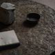 Round brutalist coffee table in stone and steel, mid-century French modernism, 1970s.