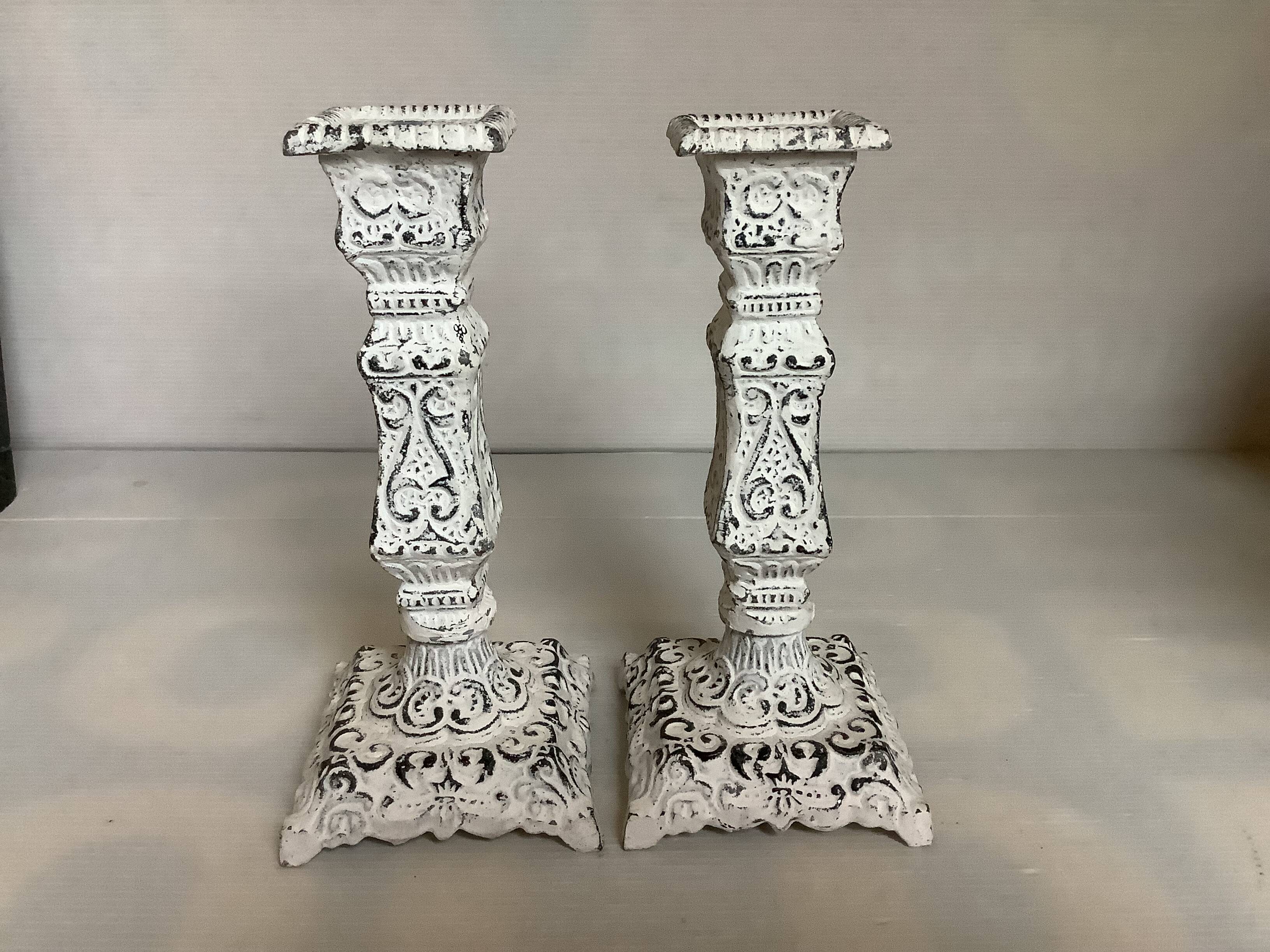 Pair of patinated cast iron candlesticks