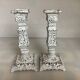 Pair of patinated cast iron candlesticks