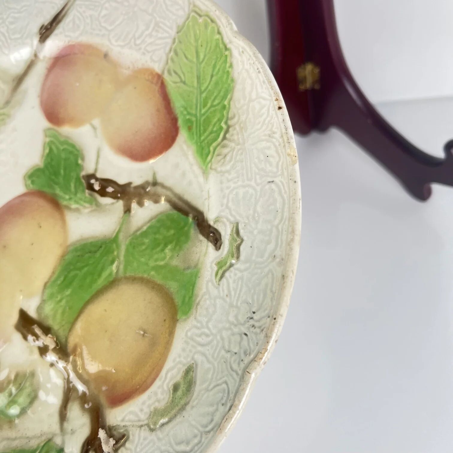 Set of 4 plates KG St Clément barbotine fruit (cherry, mirabelle, grape, pear), late 19th-early 20th century.
