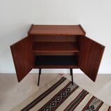 Piece of furniture on high feet metal compass